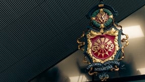Close-up of the Rothschild & Co New Court office sign mounted on a dark wall. The sign displays the Rothschild family motto, “Concordia, Integritas, Industria.