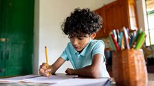 Boy drawing at desk