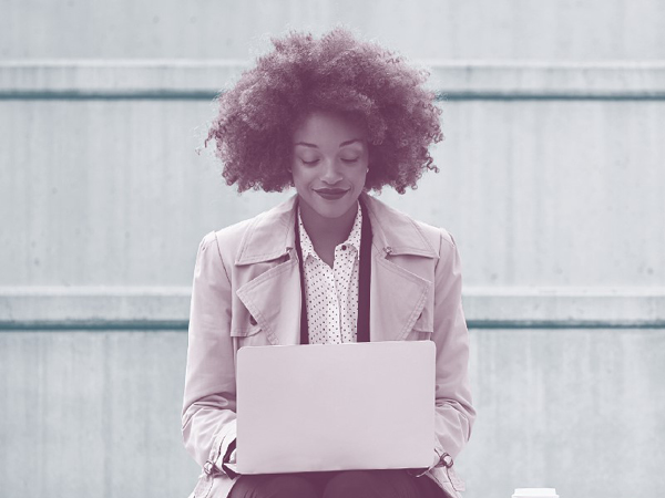 Image of a lady working on a laptop